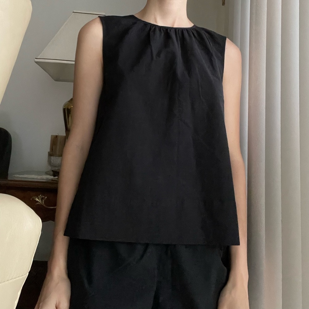 Cute black Everlane top with tie detailing in back.